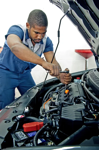 Confident Young Mechanic Checking Under Hood Of Vehicle