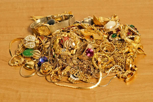 Large Pile Of Gold Jewelry On Wood Counter