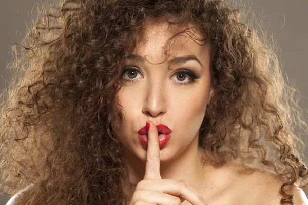 Woman making silence gesture