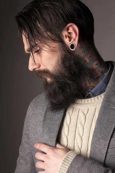 Beard, tattoos and ear-piercing