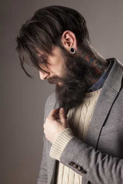 Beard, tattoos and ear-piercing