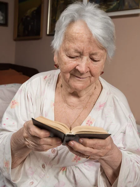 Old woman reading the Bible