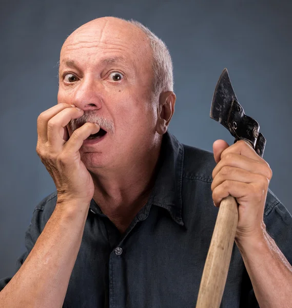 Angry elderly man with an ax