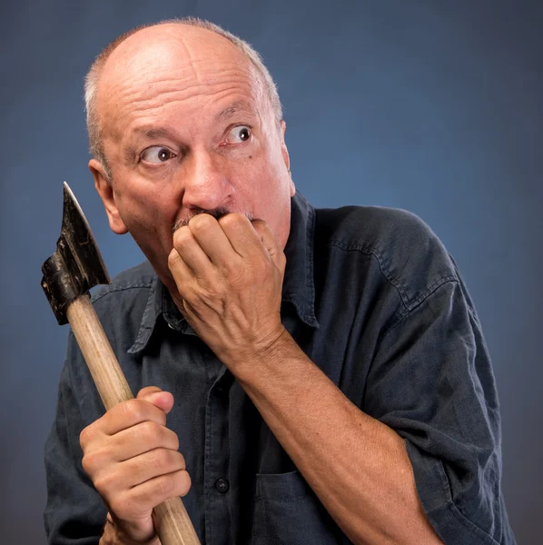 Angry elderly man with an ax