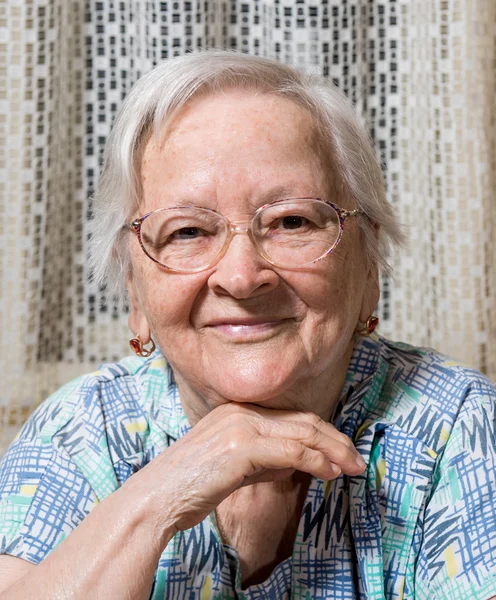 Smiling old woman in glasses