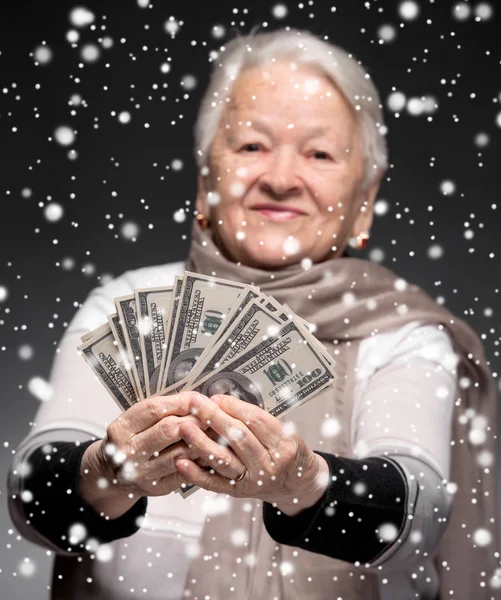 Old woman holding money in hands