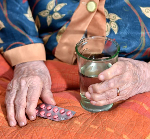 Old woman going to take pills