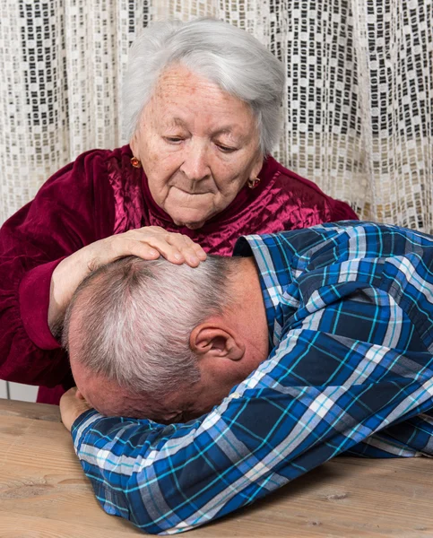 Old mother with sad elderly son