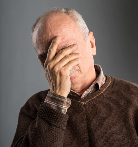 Elderly man suffering from a headache