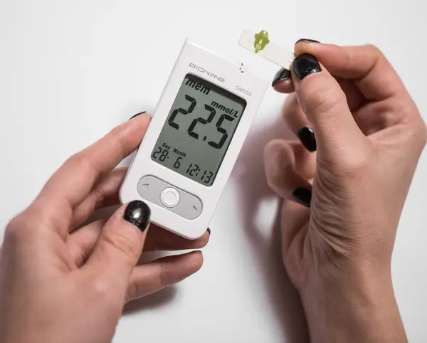 Young woman checking blood sugar level
