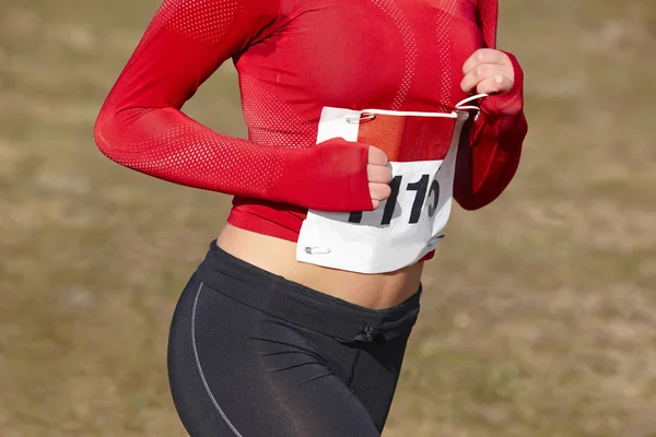 Female athletic runner with sweat. Cross country race. Outdoor c