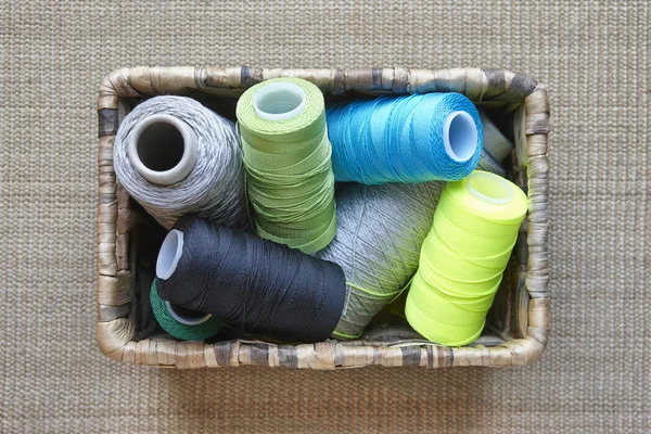 Multicolored sewing thread detail on a basket