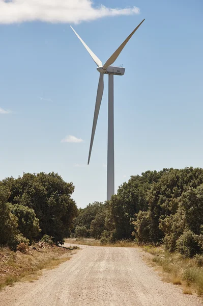 Wind turbine and gravel road. Clean alternative renewable energy