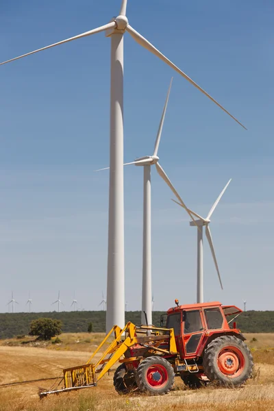 Wind turbines and tractor countryside. Clean alternative renewab