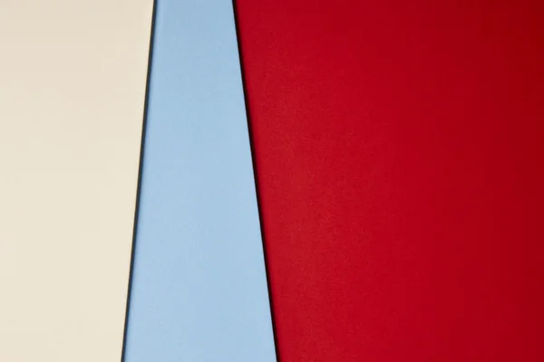 Colored cardboards background in beige blue red tone. Copy space
