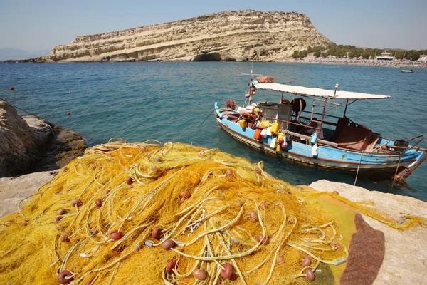 Matala beach with fishing boat in Crete. Greece