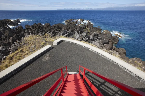 Coastline viewpoint with red stairs in Pico island. Azores. Port