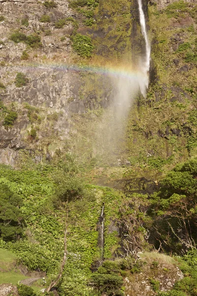 Waterfall and rainbow in Flores island, Azores. Poco do Bacalhau