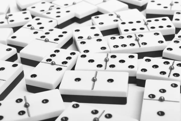 Domino game with pieces over a white background. Black, white