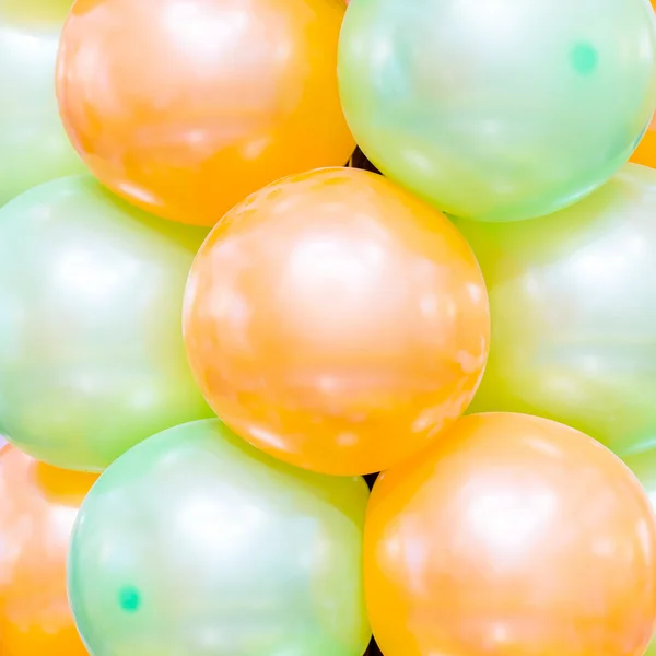 Orange and green balloons background.