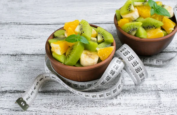 Fruit salad with kiwi, banana and orange for slimming and centim