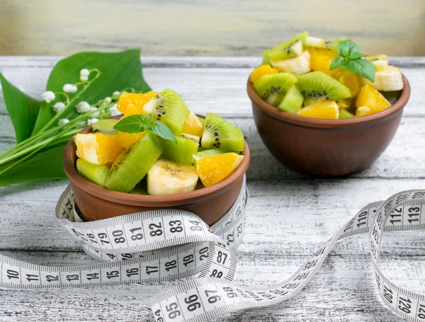 Fruit salad with kiwi, banana and orange for slimming and centim