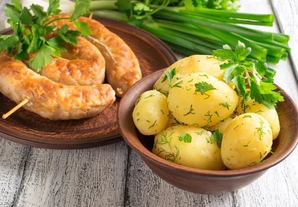 Young boiled potatoes with dill, sausage, parsley and onions