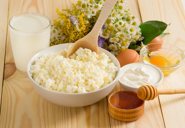 Cottage cheese and other Ingredients on the meadow flowers backg