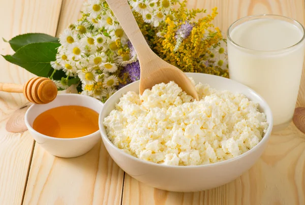 Cottage cheese and other Ingredients on the meadow flowers backg