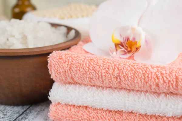 Spa salon with sea salt, towels and flowers