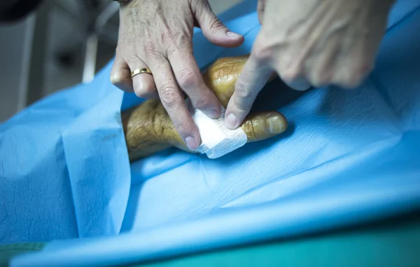 Surgeon doctor injecting patient in hospital clinic