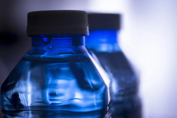 Isolated plastic water bottle plain blue background studio shot