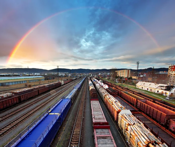 Train Freight transportation with rainbow - Cargo transit