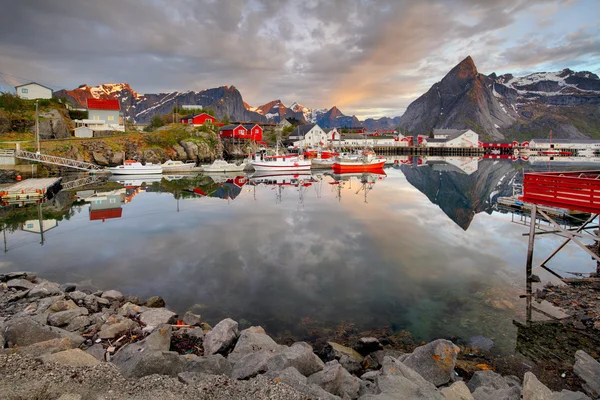 Norway coast with boat and red huts, Reine