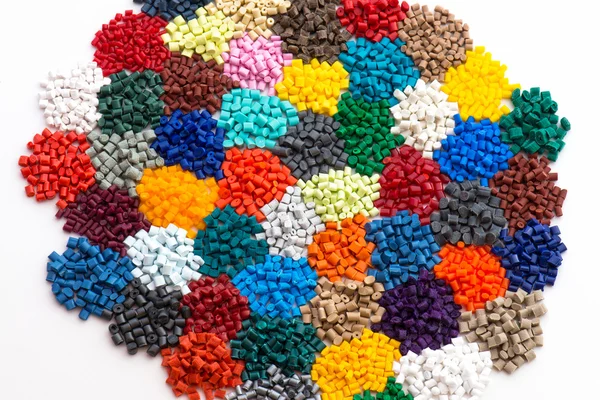 Heaps of dyed plastic granulate