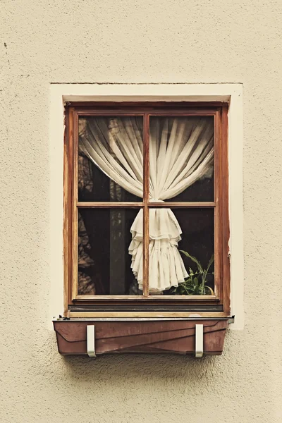 Vintage wooden window frame with curtain
