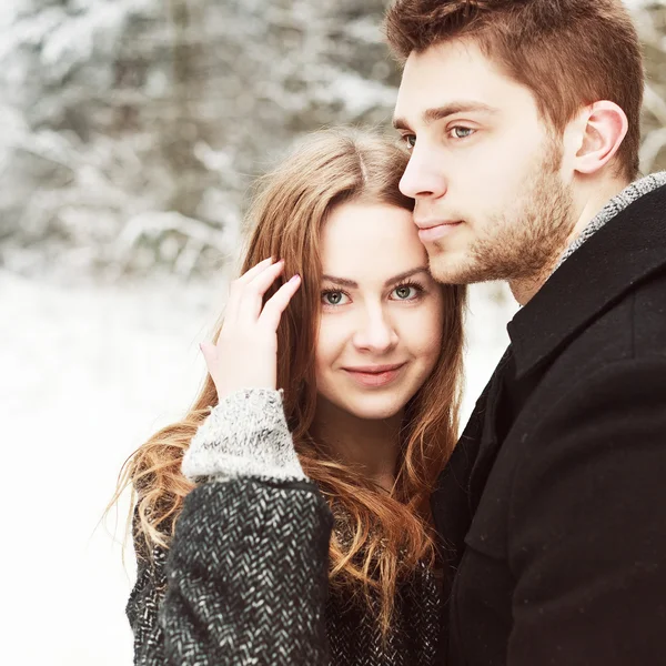 Couple in love posing in winter forest