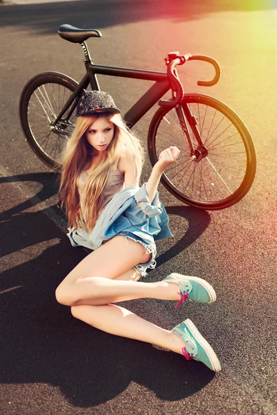 Blonde girl posing  with bicycle