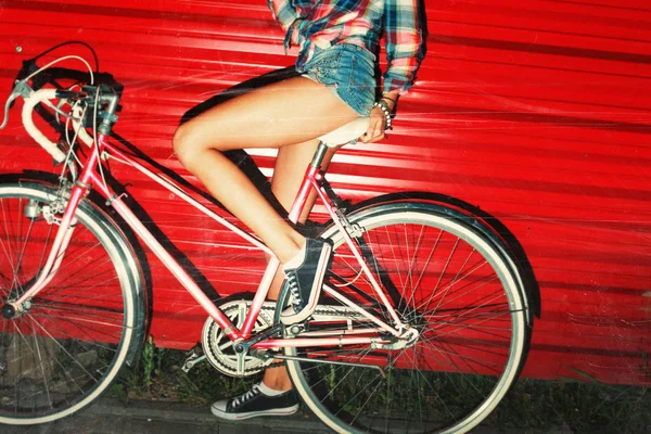 Young girl posing with sport bicycle