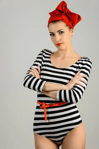 Studio portrait of a beautiful woman in sailor stripes swimsuit