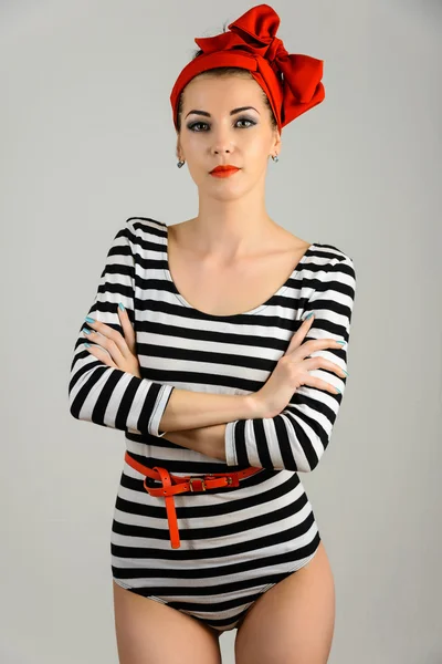 Studio portrait of a beautiful woman in sailor stripes swimsuit