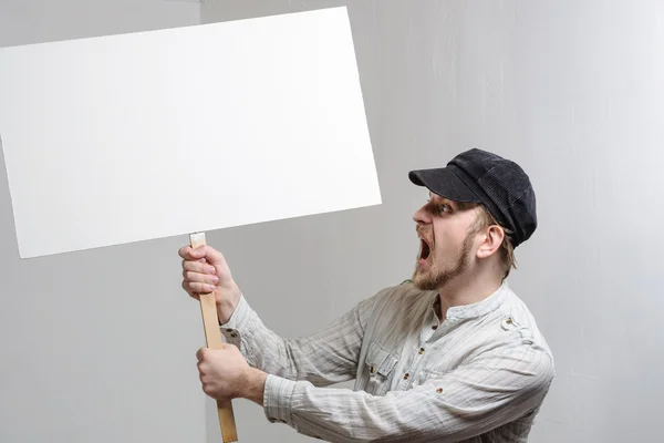 Angry protesting worker with blank protest sign