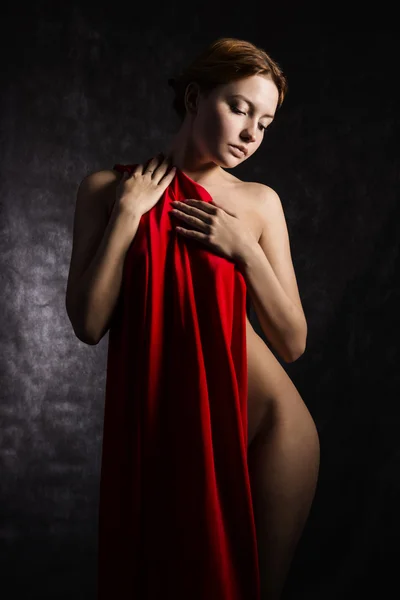 Beautiful woman with red tissue around her waist