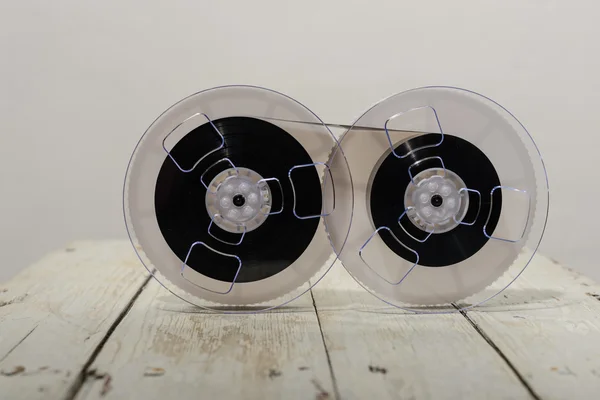 Magnetic tape on wooden background.
