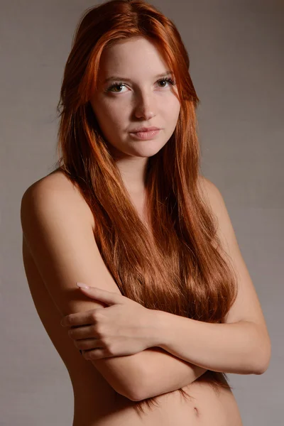 Fashion portrait of redhead woman with long hair