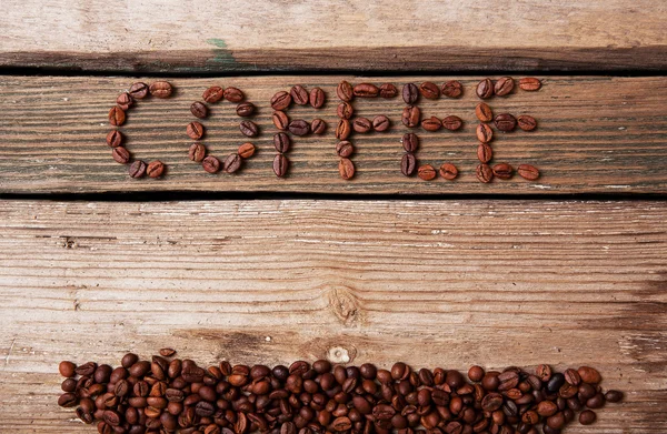 Coffee beans and cup on wooden background