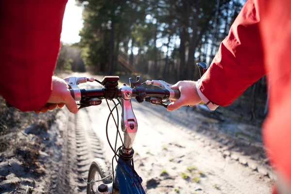 Hands holding handlebar of a bicycle