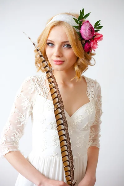 Beautiful bride posing with long feather