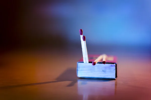 Match box and match sticks lying on floor