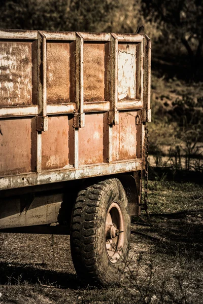 Old farm trailer on a fallow field.